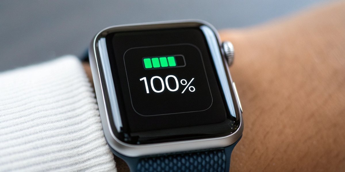 Close-up of a smartwatch screen showing a 100% full battery icon