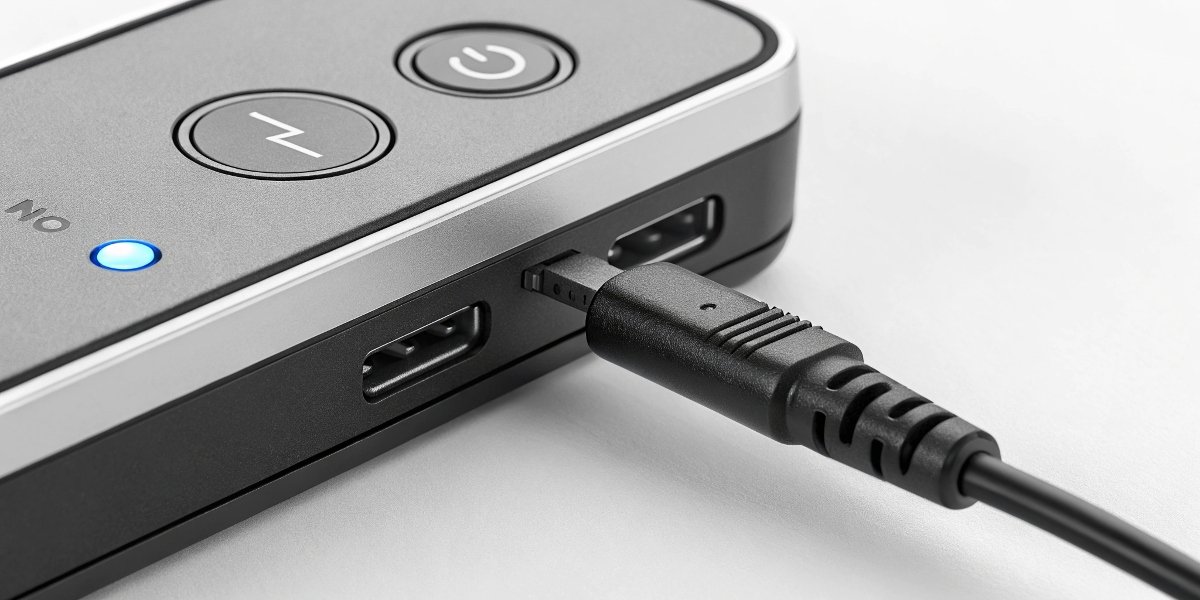A close-up on the mode selection button of a smart charger, with an arrow pointing to the correct "LiFePO₄" setting